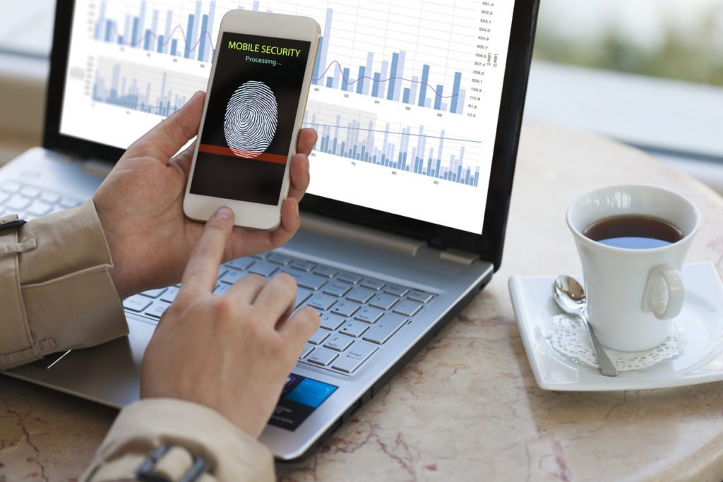 Man using a phone to access physical cybersecurity protocols