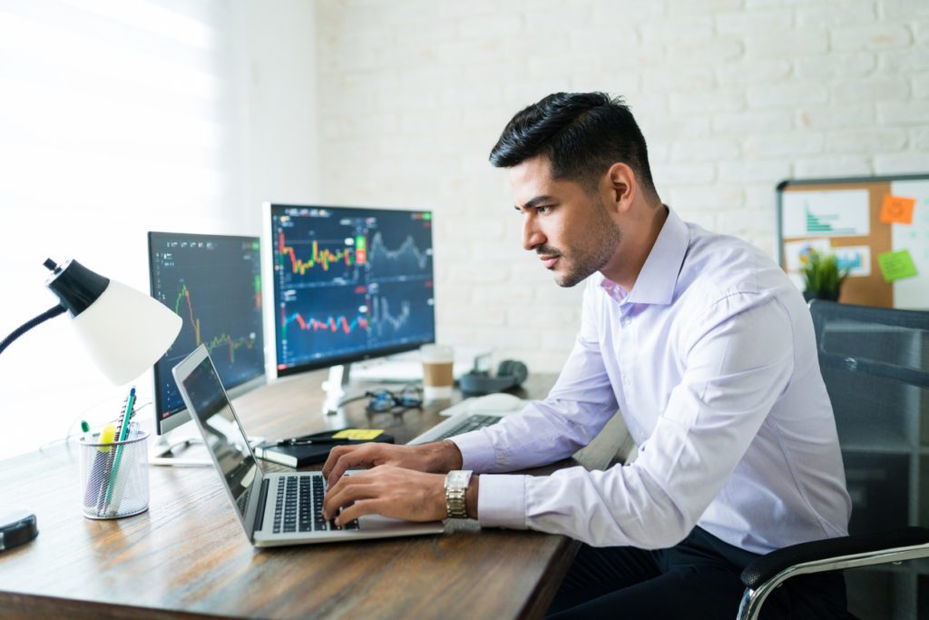 Financial charts displayed on multiple screens as a financial analyst uses Microsoft Cloud.