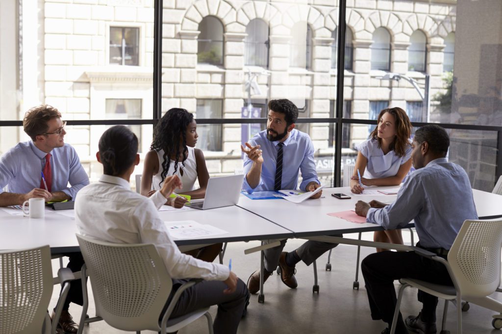 A business meeting to discuss avoiding divestiture hazards.