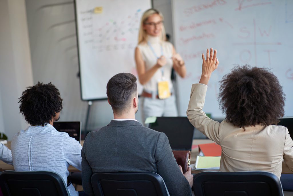 A female manager upskilling her IT team with a new IT presentation.